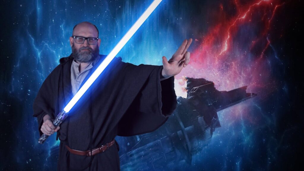 Photo of author David Morey dressed as a Jedi and holding a light saber, with a space background.