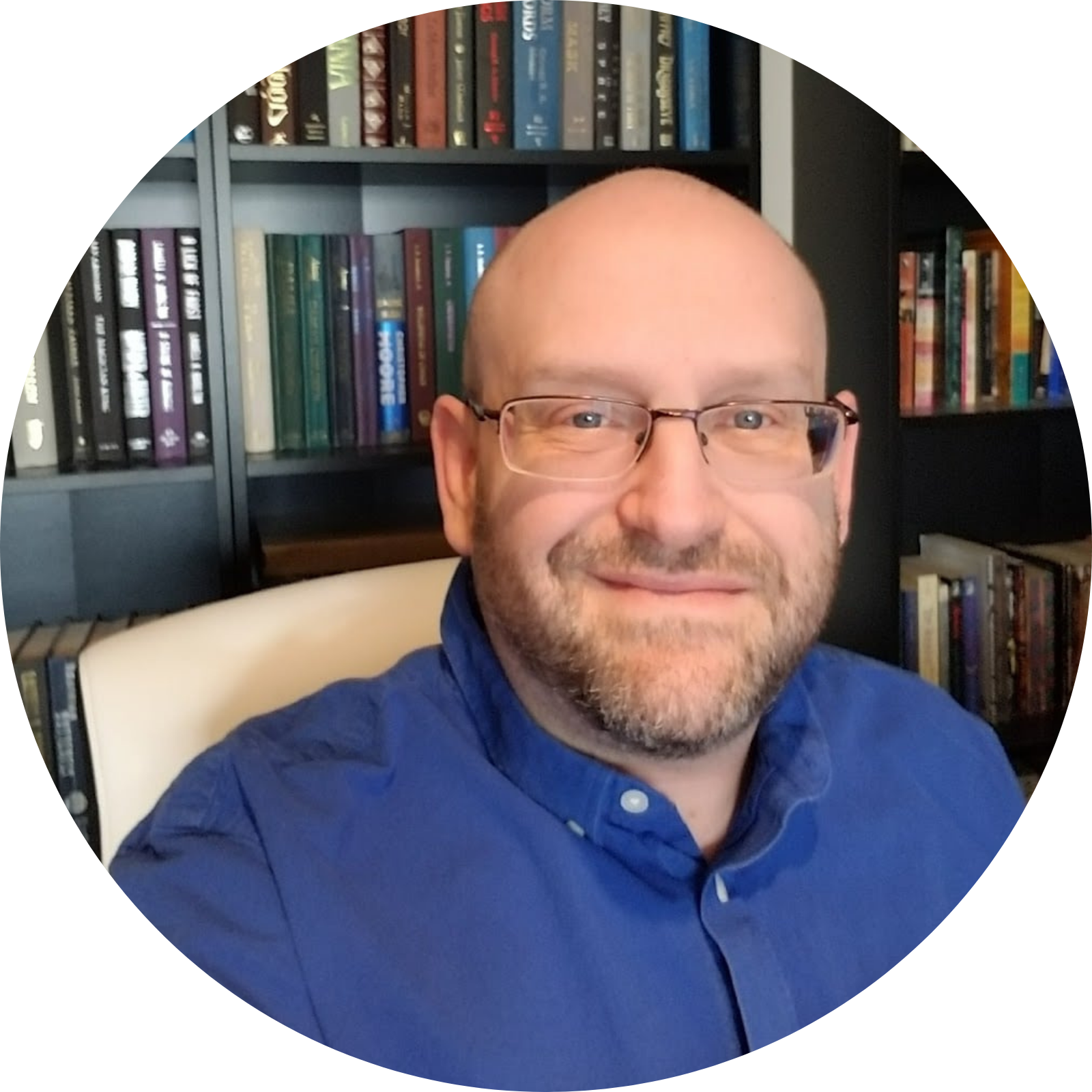 Photo of author David Morey in a blue button-down shirt, wearing glasses. He is a Caucasian male with a beard.